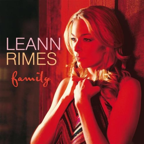 Leann Rimes poses against a red background on the cover of her album Family.