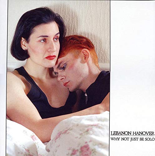CD cover: two people with dark and red hair, floral bedding.
