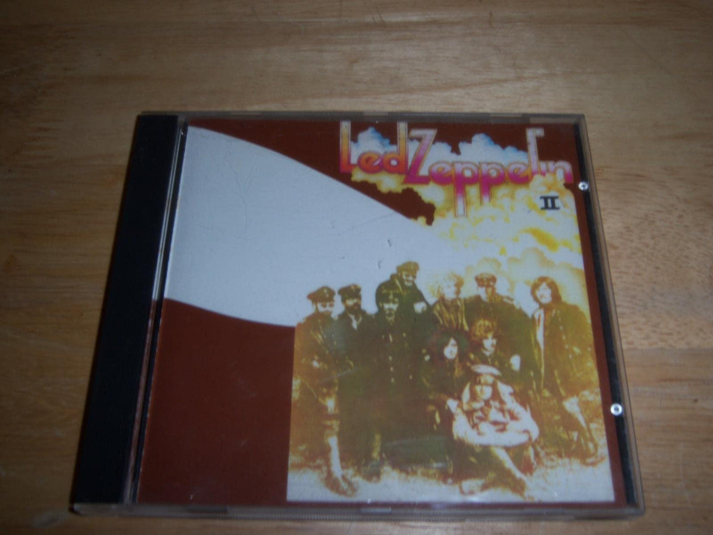 Led Zeppelin II CD case featuring the band members on a brown and white background.