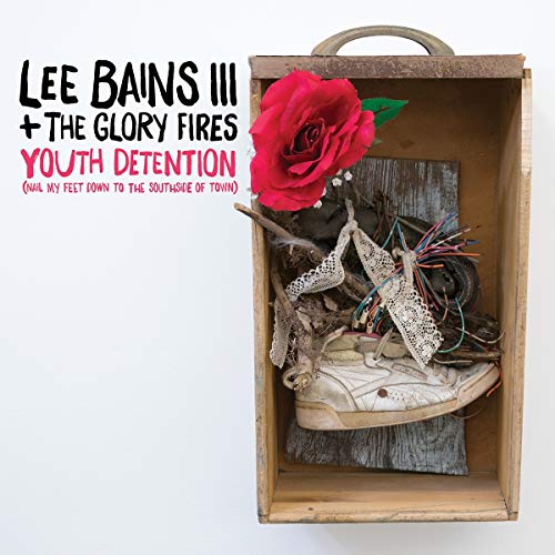 Album cover with a red rose, old shoe, and rustic wooden box.