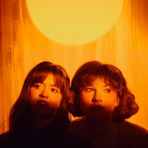 CD cover featuring two young people with long hair in warm orange light.