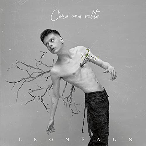 Shirtless young man with tree branches growing from his chest on grey background.