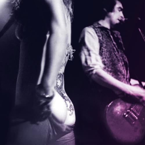 Black and white photo of two people, one playing guitar.