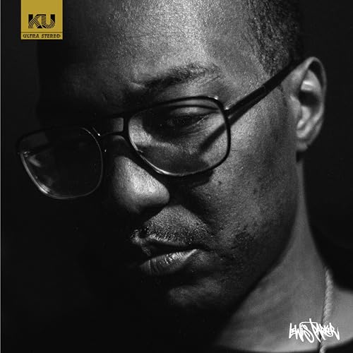 Black and white portrait of a man wearing glasses, vinyl record cover.