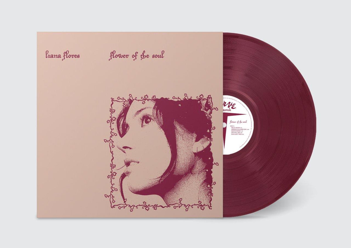 Red vinyl record with a portrait of a woman in a floral frame.