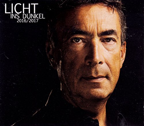 CD album cover featuring a close-up of a man's face against a dark background.