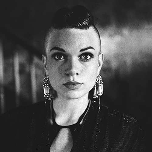 Black and white portrait of Lillie Mae, with short hair and earrings.
