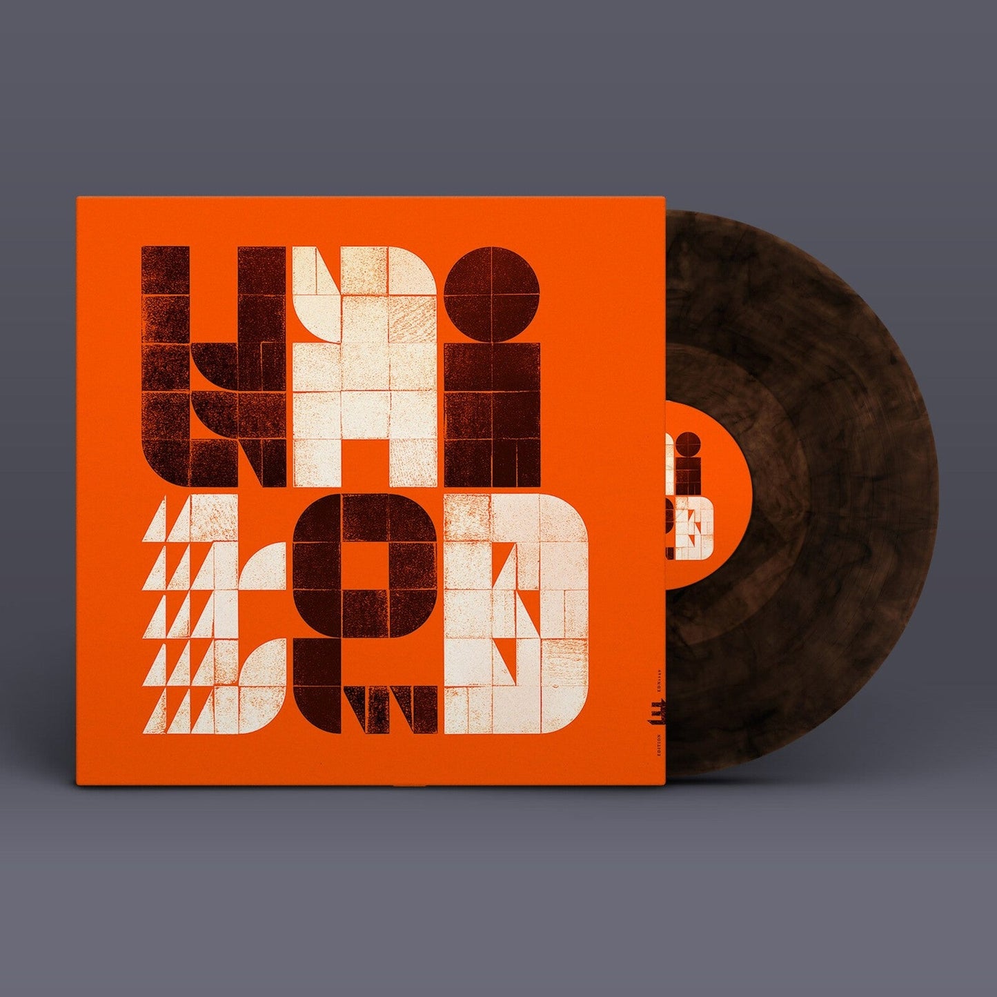 Vinyl record and album cover with bold, geometric orange and beige typography.