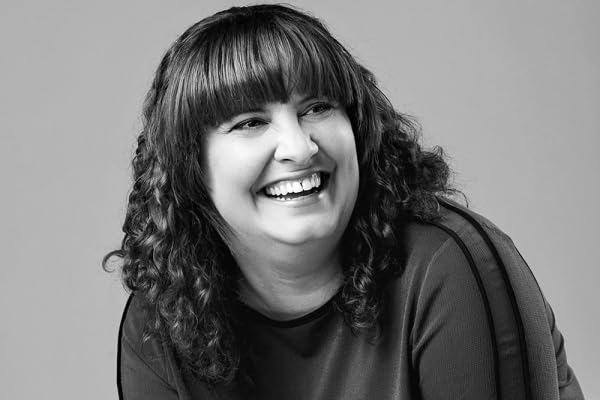 Black and white portrait of author, Freya Marske, smiling warmly.