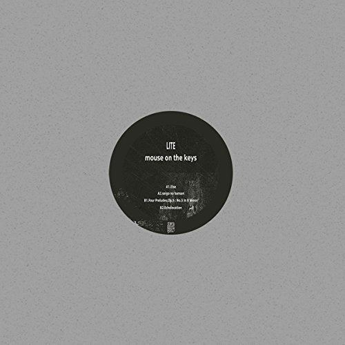 Black vinyl record label with white text on a gray background.