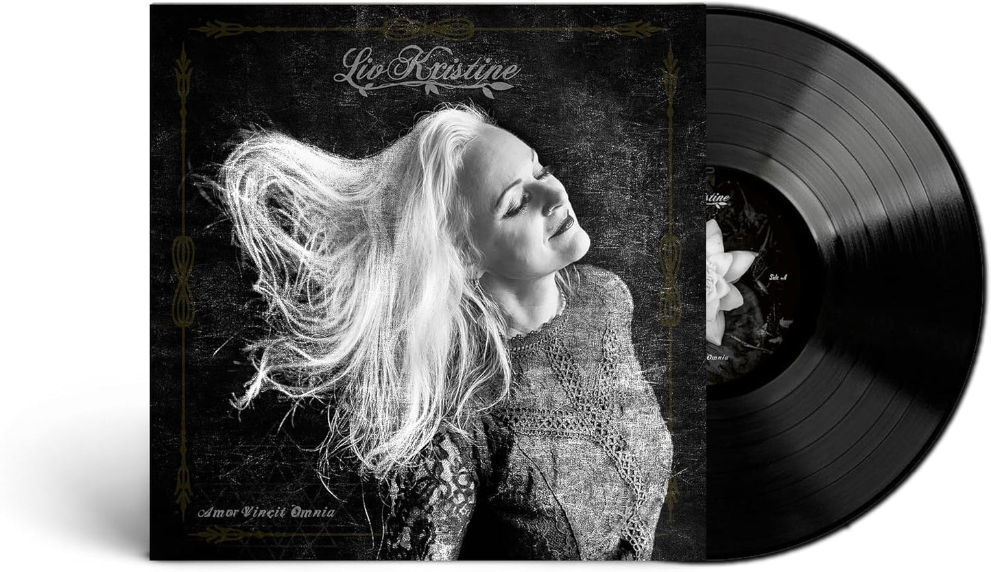 Liv Kristine album cover with a woman and vinyl record shown.