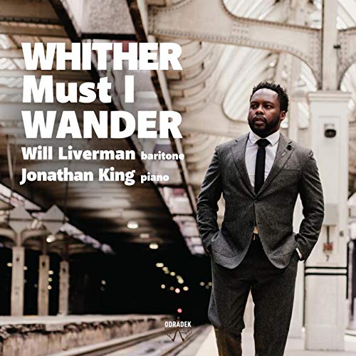 "Album cover featuring a man in a suit standing under an arched bridge."