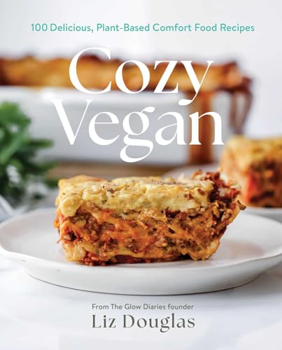 Cookbook cover titled Cozy Vegan featuring a slice of lasagna on a white plate.