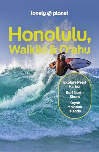 A surfer rides a large ocean wave on the cover of a Lonely Planet guidebook.