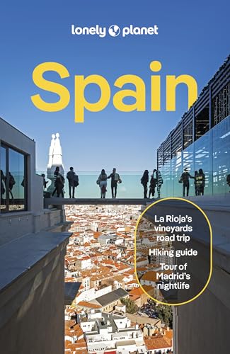 Lonely Planet Spain travel guide cover showing people on a rooftop overlooking a city.