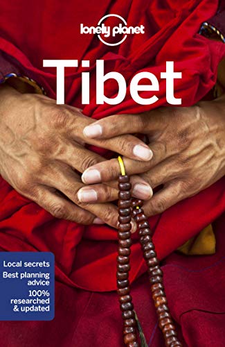 Lonely Planet travel guide to Tibet, featuring hands with prayer beads.