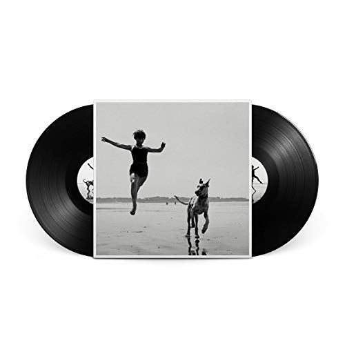 Vinyl record with black and white cover art of a jumping figure and dog.