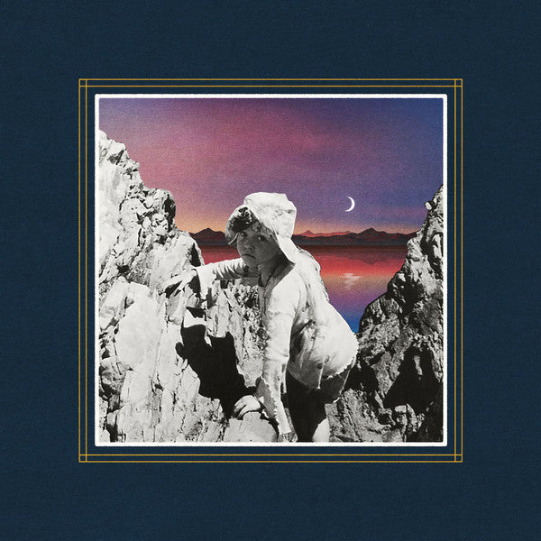 Person in white climbing rocks, sunset and crescent moon backdrop.