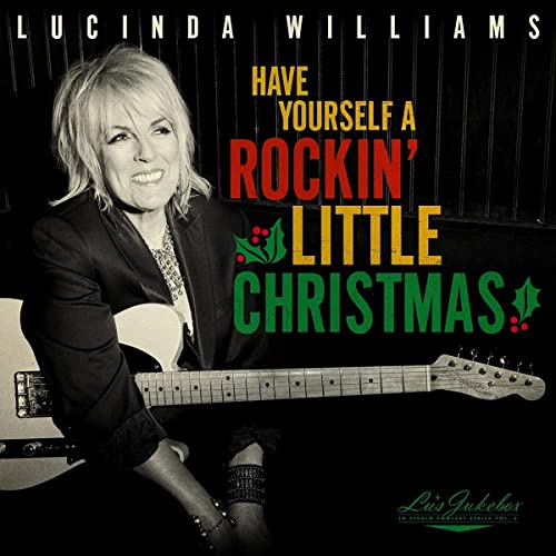 Lucinda Williams album cover featuring her with a guitar, Christmas theme.