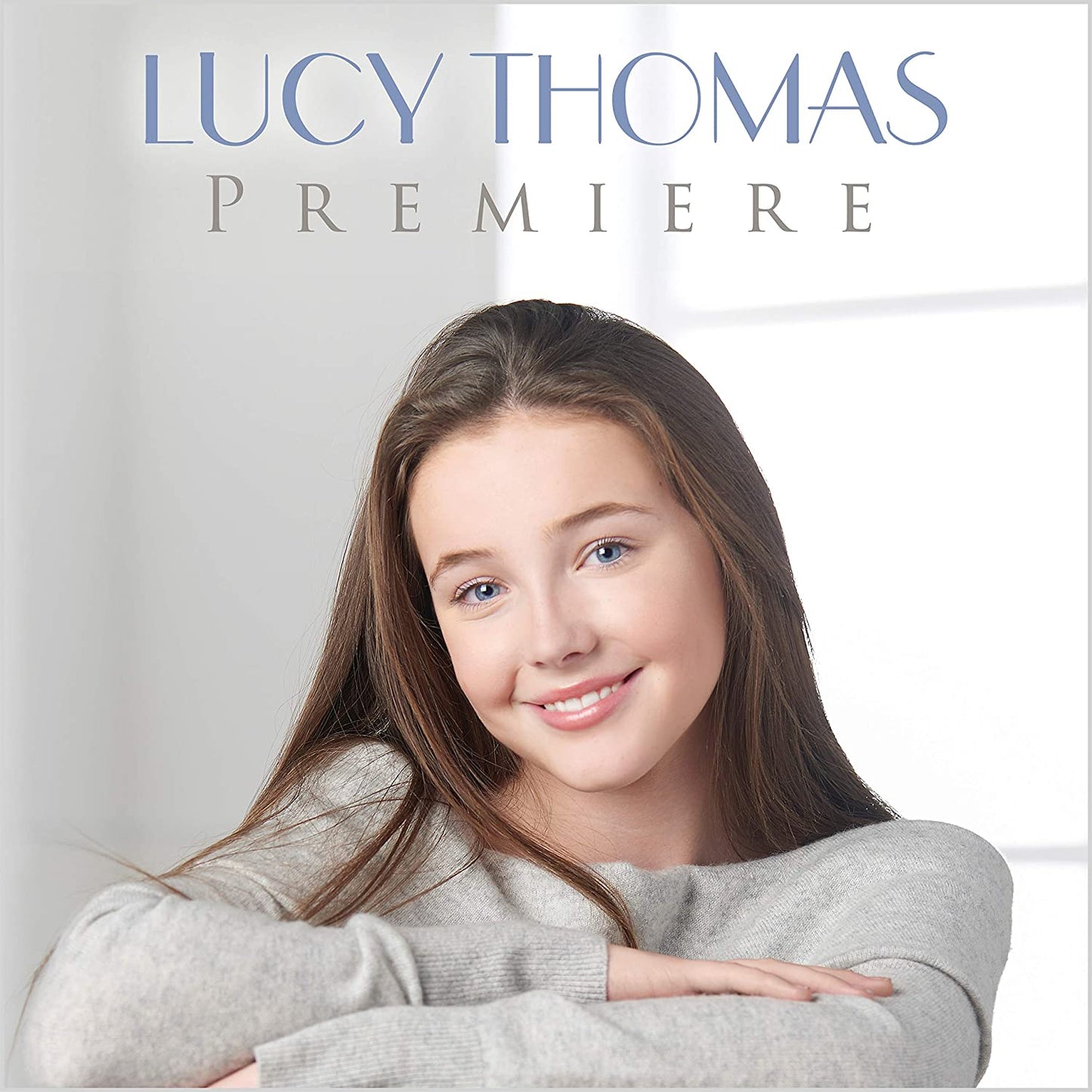 Album cover featuring a smiling young woman with long brown hair and grey sweater.