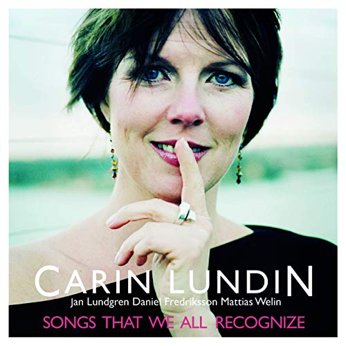 Carin Lundin holding a finger to her lips on the album cover.
