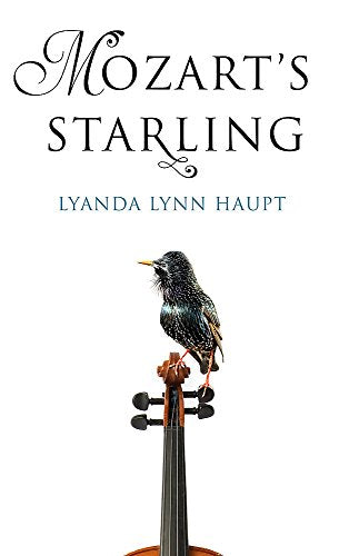 A starling perched on the scroll of a violin against a white background.