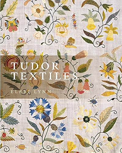 Book cover featuring intricate floral and insect embroidery on a light linen background.