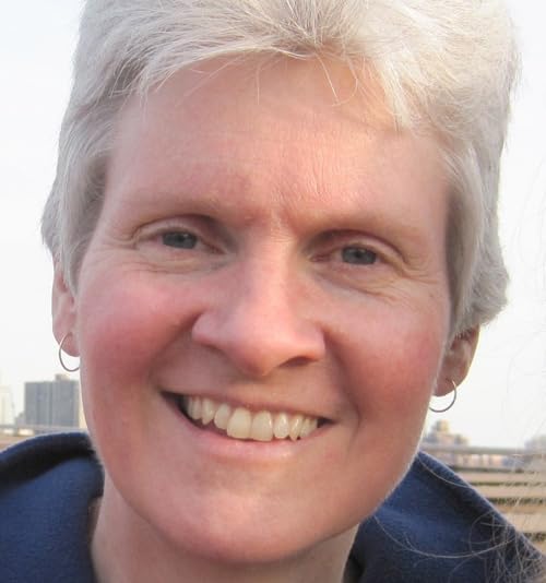 Close-up of a smiling woman with short gray hair.