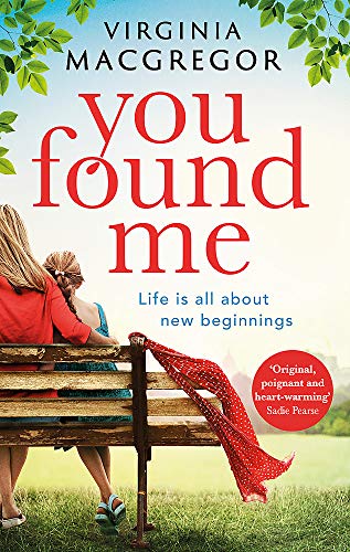 Book cover: two women on a bench, red scarf, green foliage.