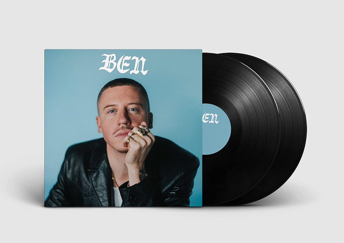 Macklemore album cover featuring the artist next to two black vinyl records.