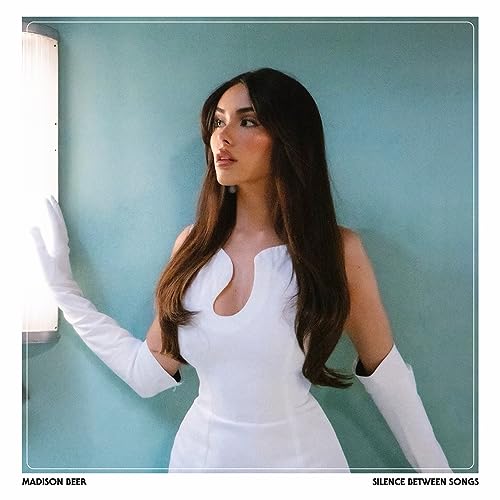 Madison Beer portrait for album “Silence Between Songs” with teal background.