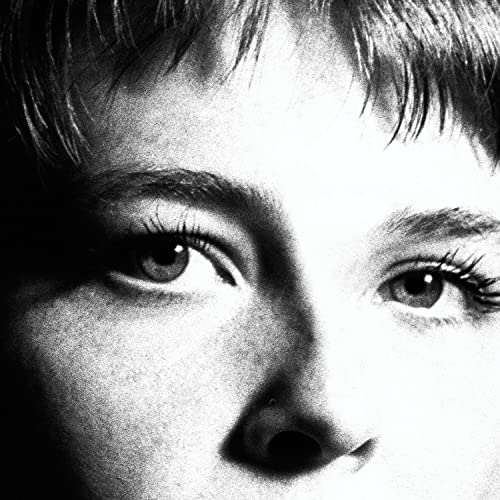 Black and white close-up of Maggie Rogers’ face, focusing on her eyes.