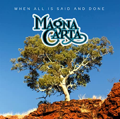 Magna Carta album cover with band logo and desert tree.