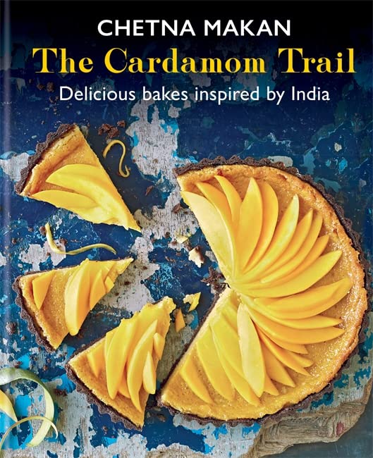 Book cover titled The Cardamom Trail featuring a mango tart on a blue surface.