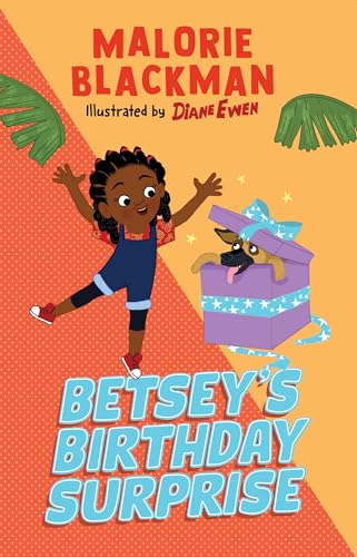 A young girl jumps with joy next to a puppy inside a birthday gift box.
