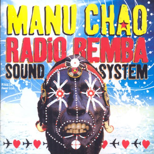 Manu Chao album cover: decorated mask with bold yellow and red text.