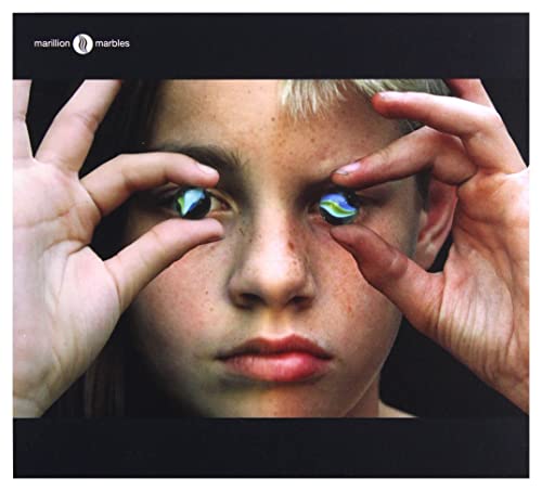 A child holds two marbles over their eyes on the Marillion Marbles album cover.