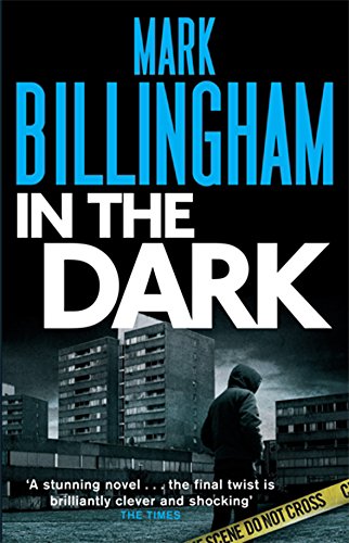 Book cover for "In The Dark" with a hooded figure and buildings.