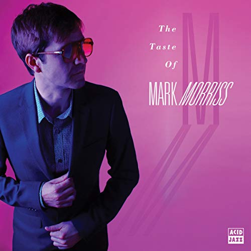 Man in suit and sunglasses on pink album cover with white text and logo.