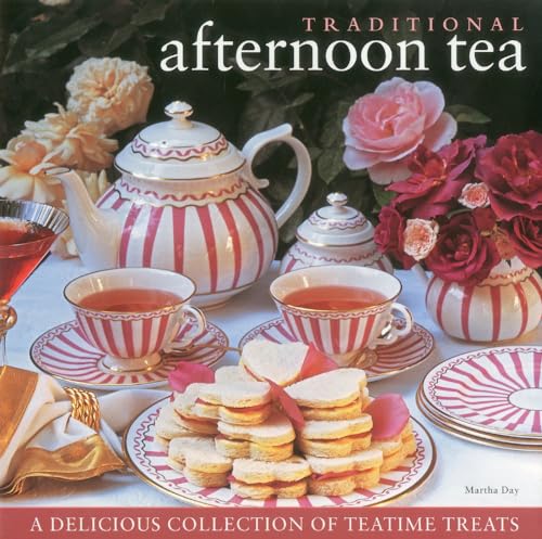 Red and white teapot, teacups, sandwiches, and roses on a table.
