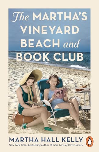 Two women in vintage swimwear sit on a beach reading books in deck chairs.