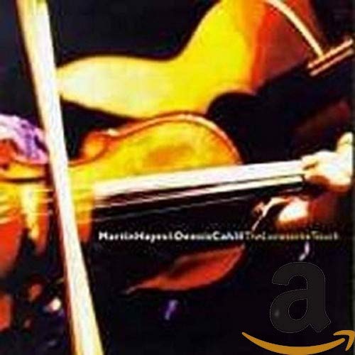 Close-up of a fiddle being played against a dark background.
