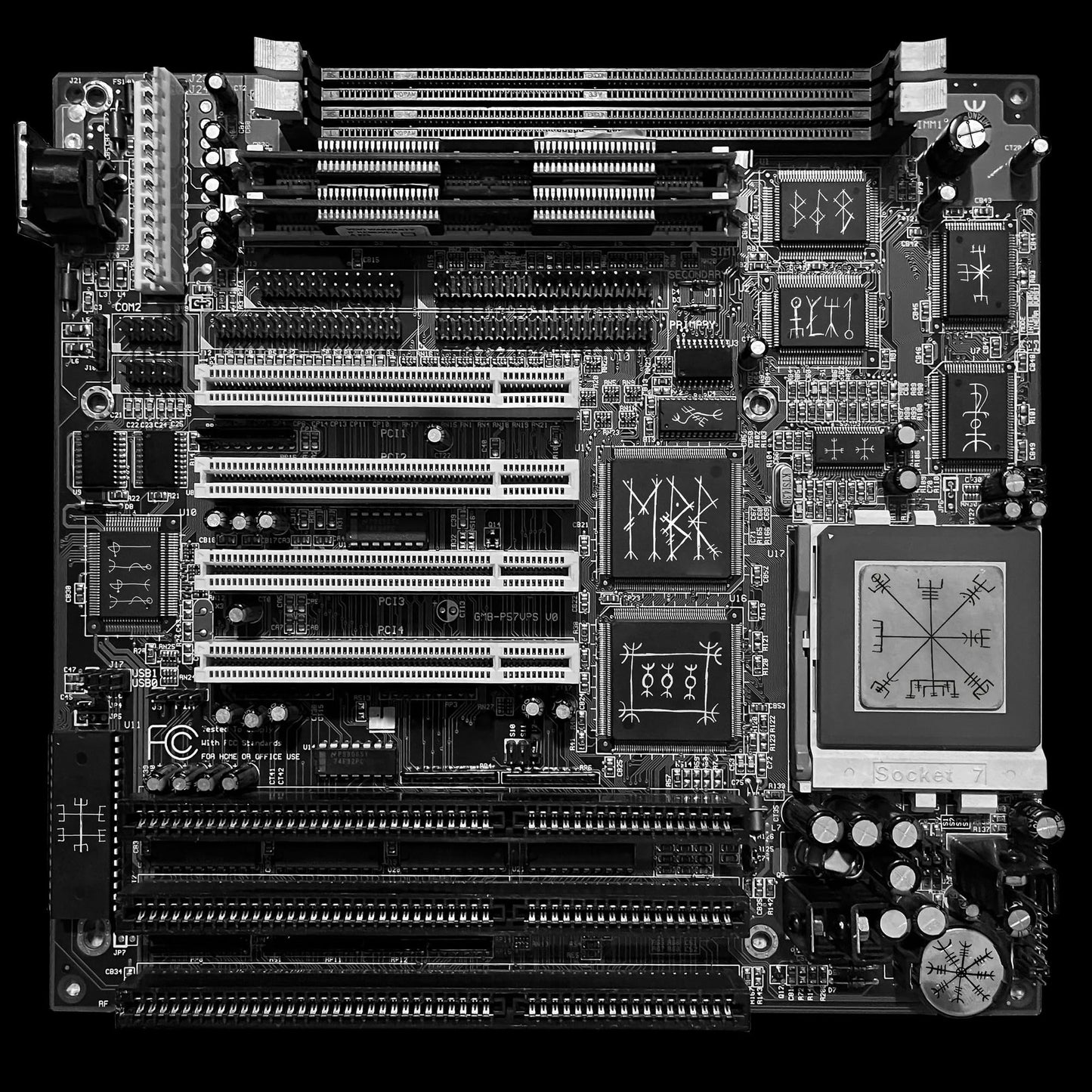 Black computer motherboard with intricate circuitry and a rune-like design.