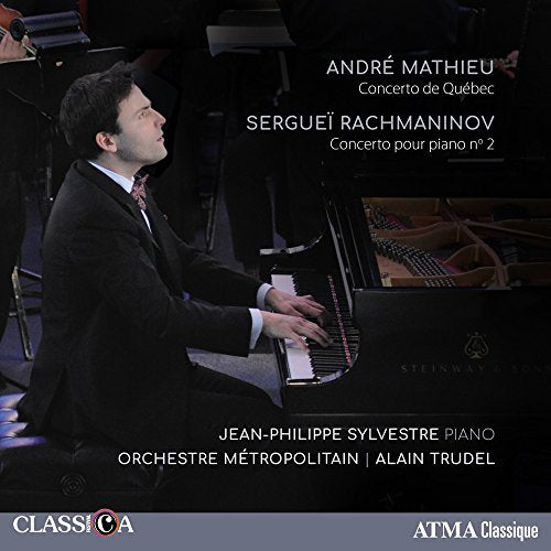 Pianist playing a Steinway grand piano with an orchestra behind him.