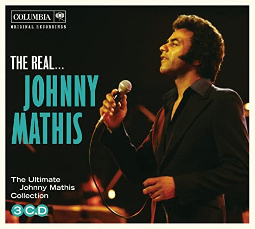 Johnny Mathis singing on stage, holding a microphone, with album title text.