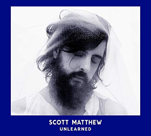 Black and white portrait of a bearded man with eyes closed, album cover.