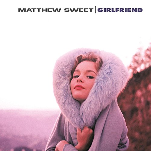 Vinyl record album cover featuring a woman in a fur-lined hood, purple-toned image.