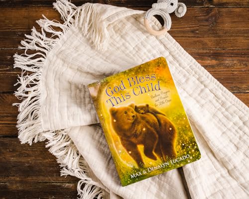 God Bless This Child book on a white fringed blanket with a toy elephant.