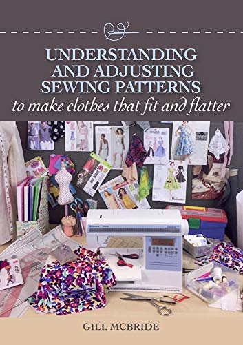 Sewing pattern book with a sewing machine, fabric, and design sketches.