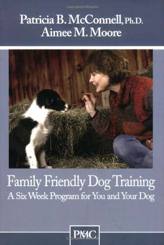 Book cover: woman kneeling, offering treat to a small black and white puppy.